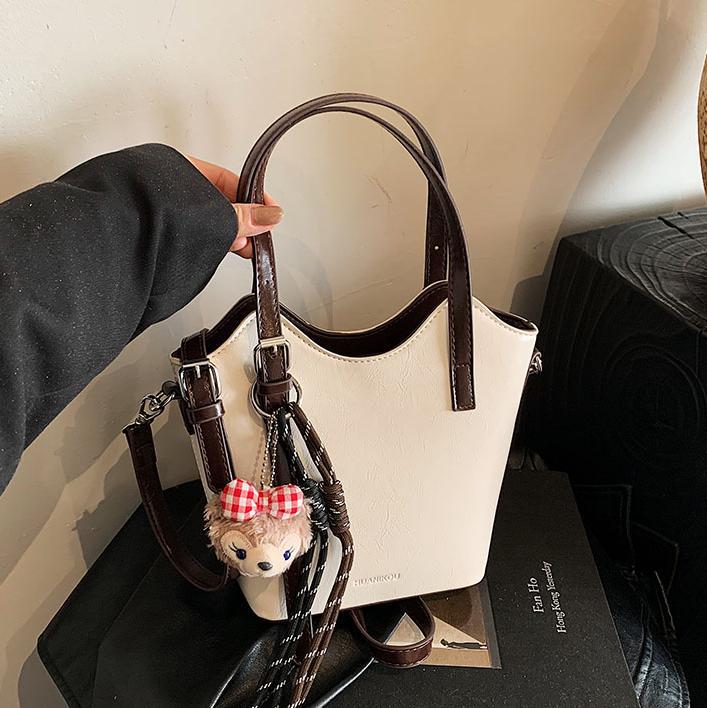 Bolsa de mano retro de color universal para mujeres 2025 nuevo nicho de diseño de tendencia bolso de hombro de alta calidad bolso de cubo