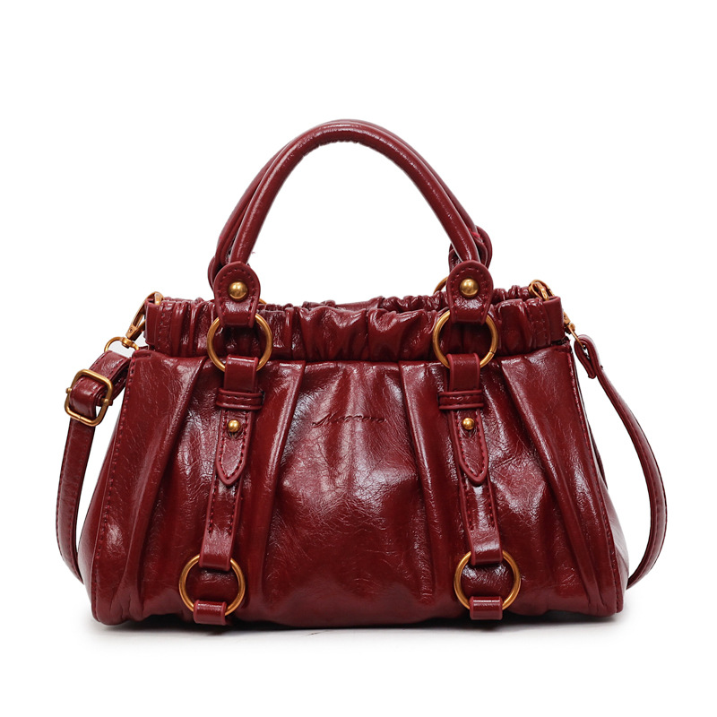 Retro bolso de mano plegable mujer 2025 otoño y invierno nuevo nicho de diseño bolso de cubo de viaje mochila de hombro