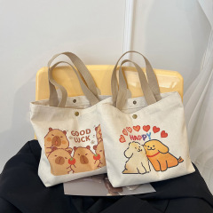 韓国系のかわいいアニメのキャンバスのカバンの女性の新型の大容量の学生の授業のカバンの袋の通勤の手は弁当のカバンを持ちます。