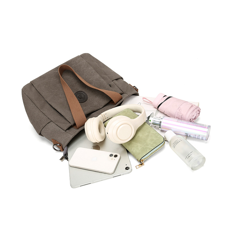 2025 bolsas de mujer europeas y estadounidenses transfronterizas nuevas bolsas de viaje de gran capacidad bolsas de hombro de lona de color sólido bolsas de brazo