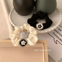 Elevated everyday style: Camellia satin scrunchie hair clip for tying and styling hair—perfect for back-of-head updos, inspired by Korean fashion.