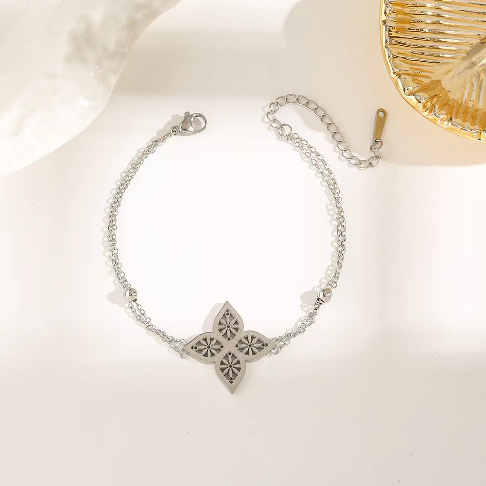 Pulsera de trébol de acero titanium vendedora caliente transfronteriza europea y americana con incrustaciones de concha pulsera colgante pulsera de diseño avanzado sin desvanecimiento al por mayor