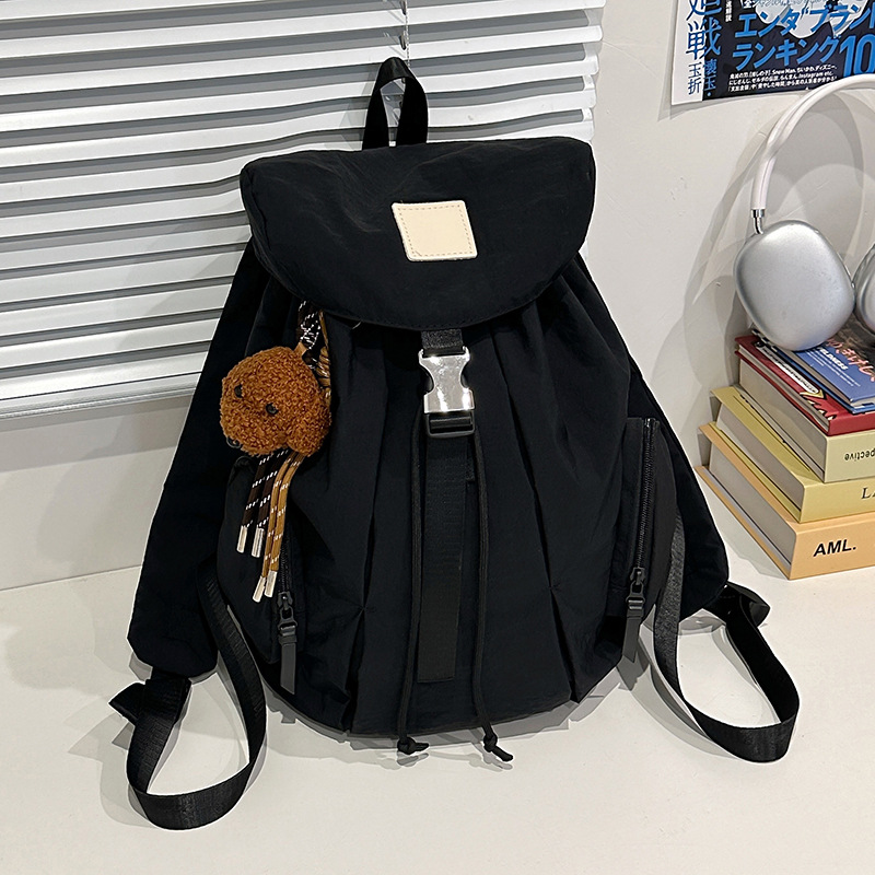Mochila de nylon de color sólido coreano a prueba de agua de gran capacidad para parejas de viajes casuales ultraligero mochila de moda cool