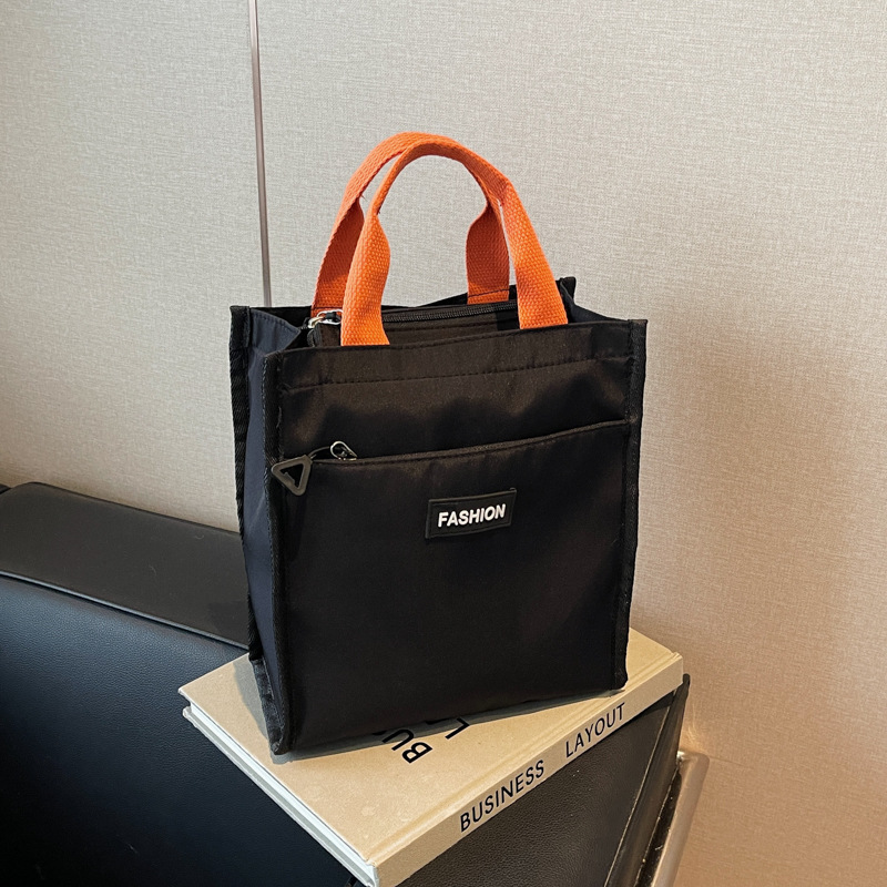 Moda coreana nueva serie de gran capacidad bolsas escolares portátiles de otoño 2024 bolsas de botellas impermeables Oxford