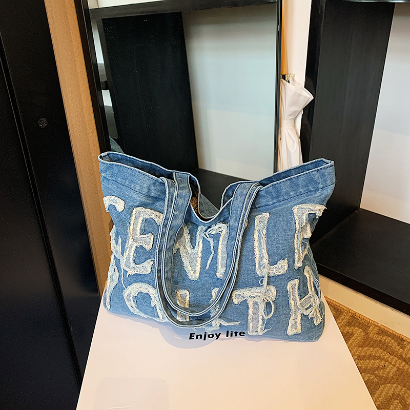 Nueva mochila de hombro de mezclilla retro, bolso de lona con letras de ocio, bolso de viaje artístico para estudiantes