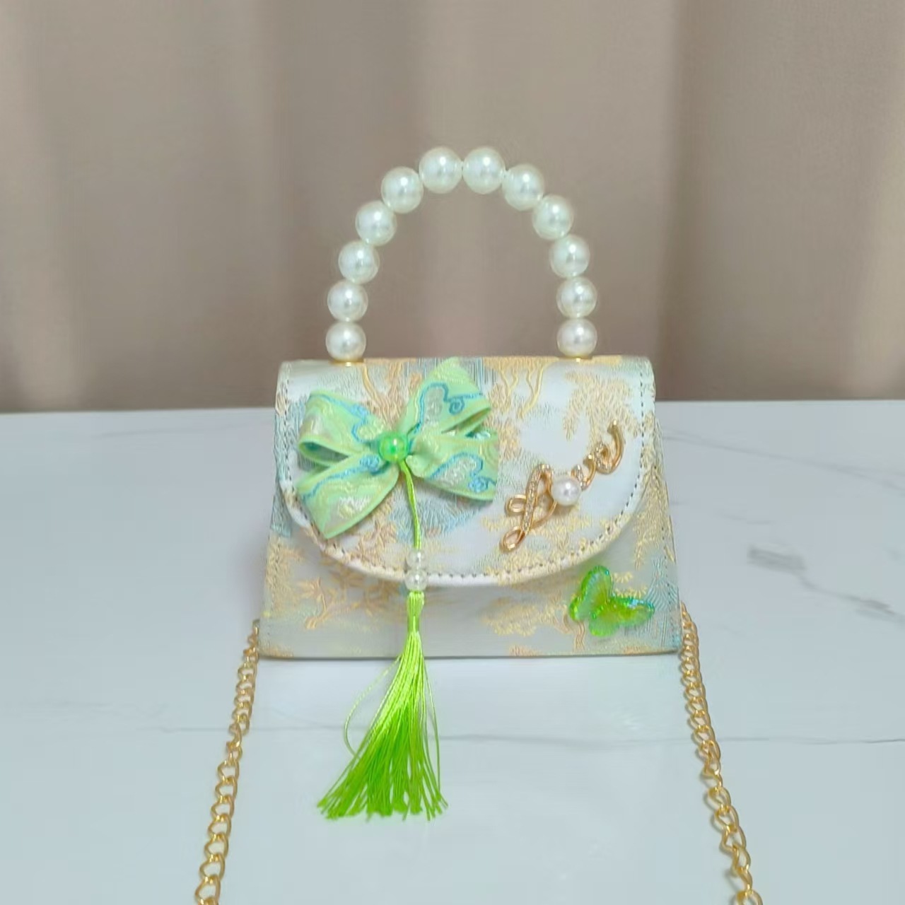 Bolsas de niños arco de estilo chino borda de niña pequeña princesa perla bolsa de cambio de mano al por mayor