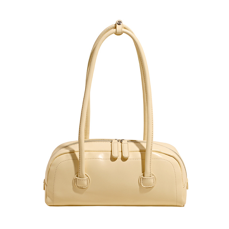 High-end nicho de moda bolso de hombro de mano para mujeres 2025 verano nuevo estilo simple bolso de viaje de palo bolso debajo de la axila
