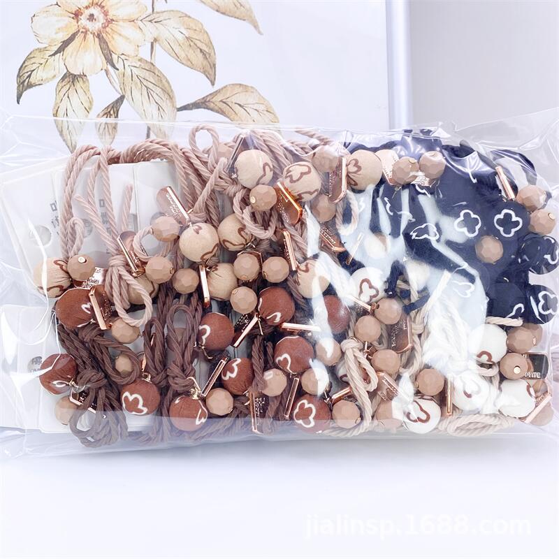 Otoño e invierno té de leche color paño bola cuerda del pelo 2 tarjetas leopardo cabeza cuerda simple hilo colgando bola banda de goma 2 yuanes tienda de suministro