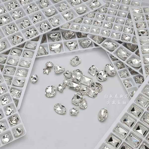 Super bright K9 white nail art rhinestones with pointed base, available in medium, small, and large sizes, featuring irregular shapes like hearts, ice candy, and plum blossoms