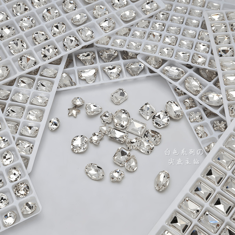 Super bright K9 white nail art rhinestones with pointed base, available in medium, small, and large sizes, featuring irregular shapes like hearts, ice candy, and plum blossoms