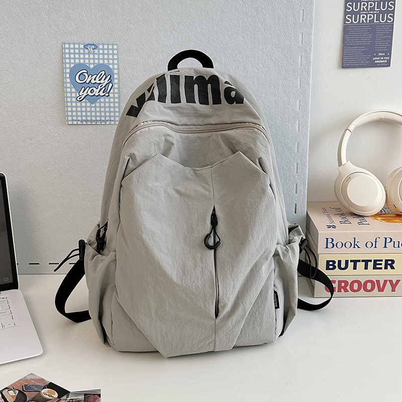 Mochila escolar 2025 nicho ligero y anti-salpicaduras de agua estudiantes de secundaria hombres y mujeres deportes de gran capacidad al aire libre mochila de viaje