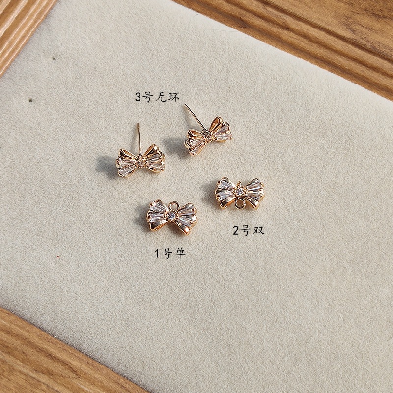 Copper earrings with zircon with bow