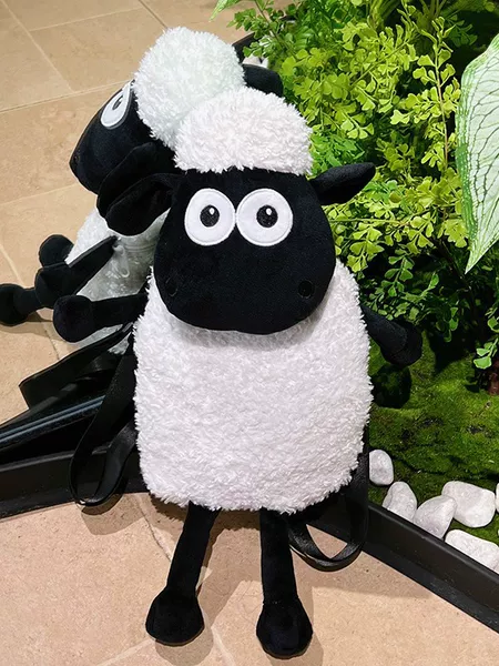 Cute cartoon-style plush toy bag featuring a long-handled, long-legged, realistic-looking lamb with a black face; a children's backpack