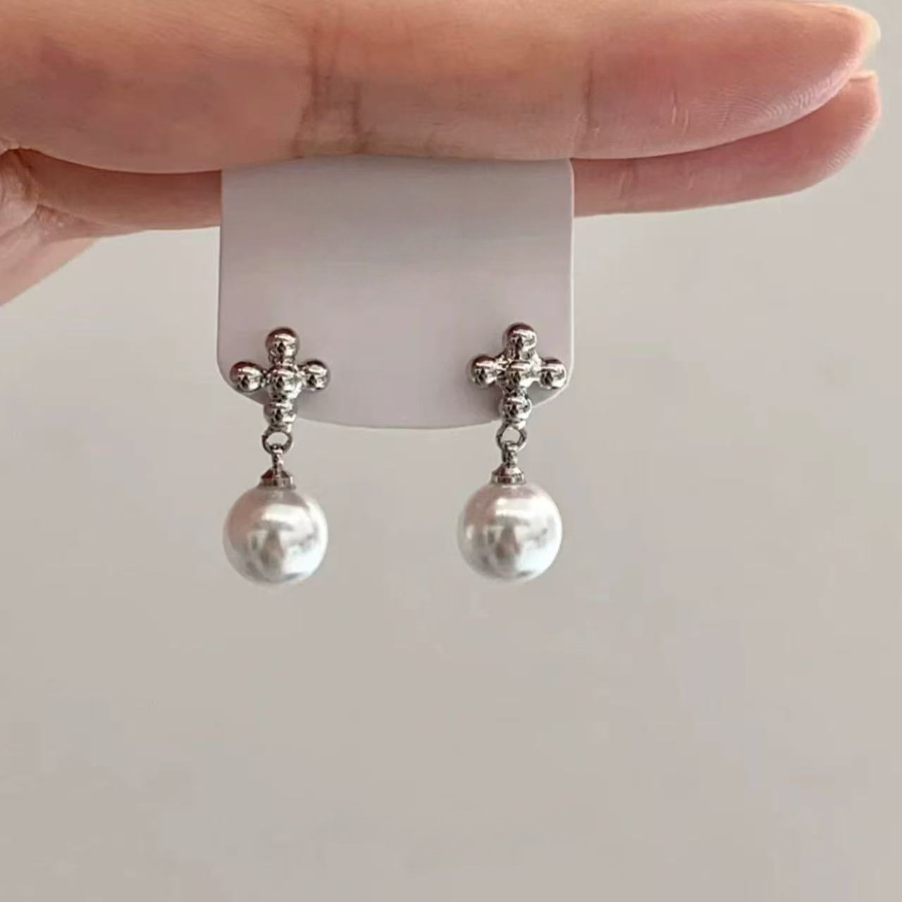 A pair of round pearl earrings