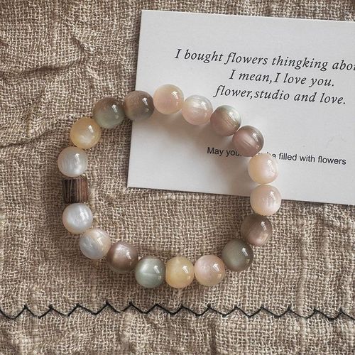 Sustainable-style, visually stunning Instagram-worthy, niche women's bracelet with a 2025 vintage pink-brown charm.