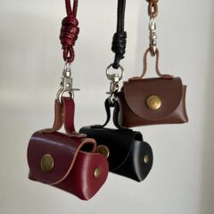 ミニバッグの小さい革の小銭入れの首のネックレスを掛けます。