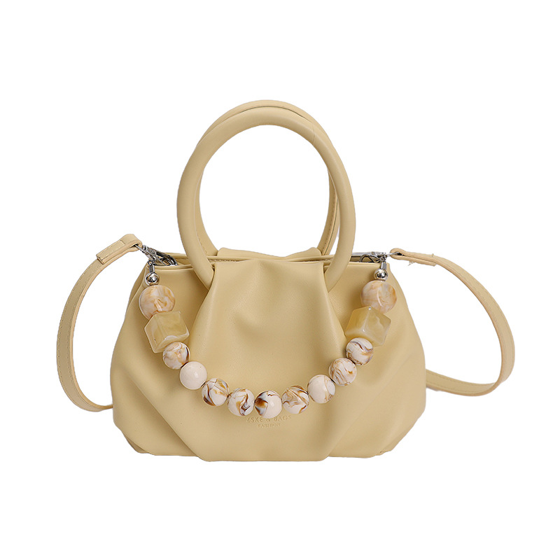 Alta sensación de mano pliegueada nube bolso de cubo para mujeres 2026 nuevo nicho de lujo ligero de moda perla bolsa de mochila