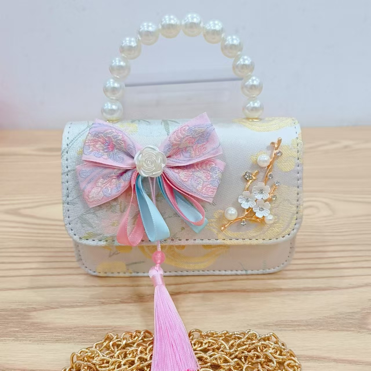 Bolsas de niños arco de estilo chino borda de niña pequeña princesa perla bolsa de cambio de mano al por mayor