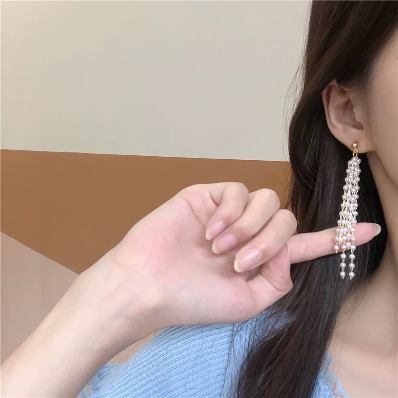 Elegant fashionable long earrings with tassels from pearl