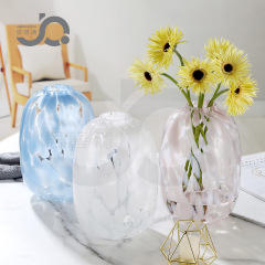 European minimalist large-bellied glass vase with snow willow, silver willow, lily, hydroponic mock orange, bellflower, orchids, water bamboo on the desktop