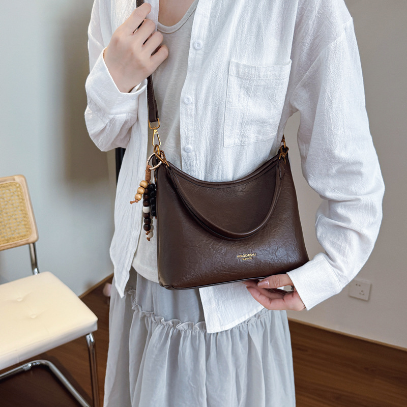 Nicho de alta sensación bolso de cuero suave para mujeres 2025 nueva moda versátil mochila de hombro mochila de viaje