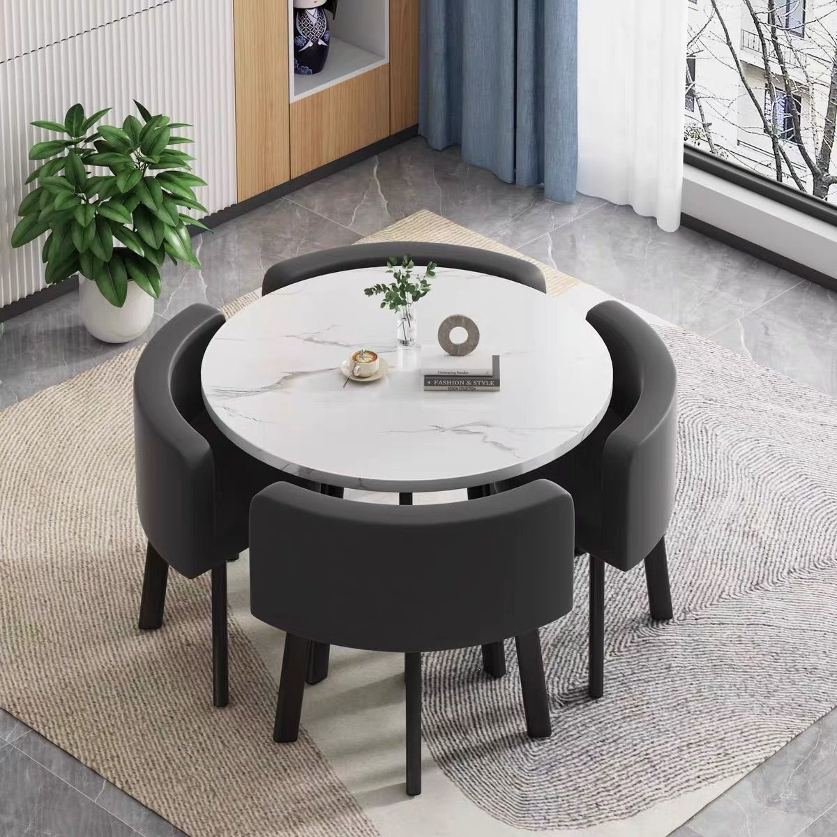 White round table + four black leather chairs
