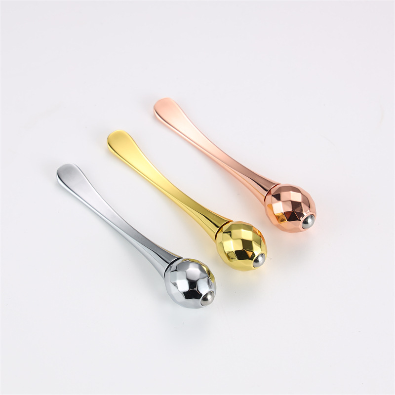Suministro transfronterizo crema de ojos con stick masajeador de bola metálica, aplicador tipo cuchara para contorno de ojos