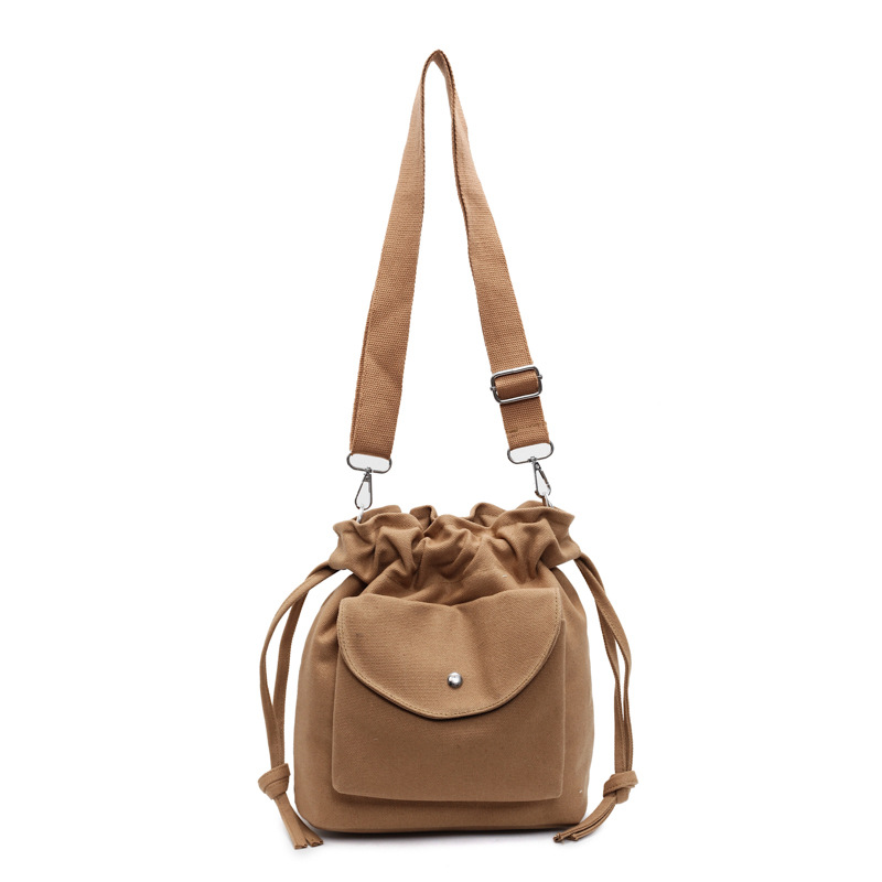 Bolsa de cubo de lona de moda de comercio exterior para mujeres 2025 nuevo estilo versátil bolso de hombro simple ocio nicho plegado mochila