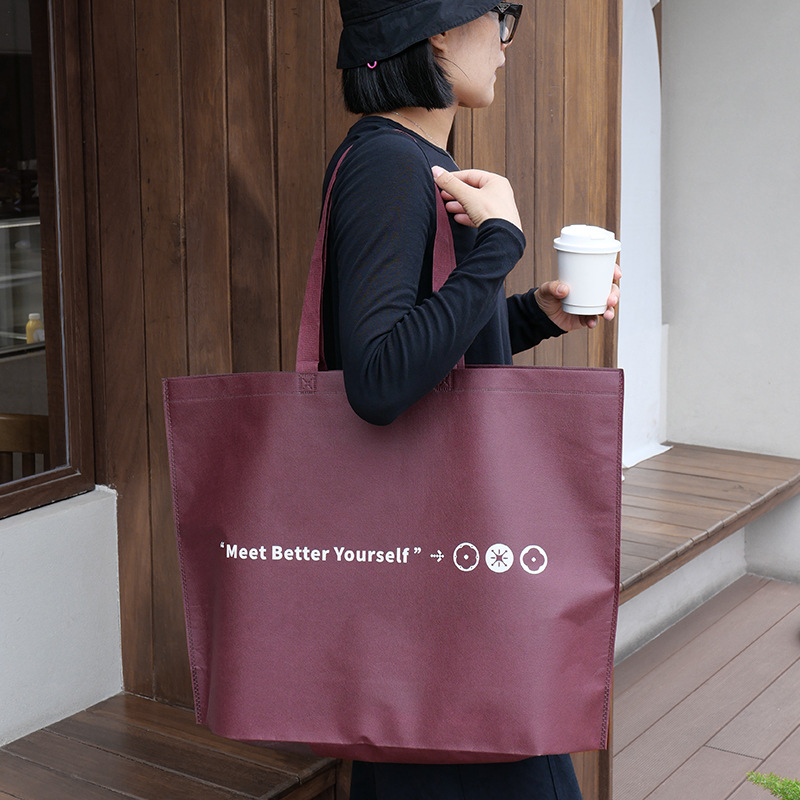 Bolso de mano no tejido de gran capacidad personalizado LOGO engrosado ropa de mujer protección ambiental bolsa de publicidad bolsa de compras de la tienda de ropa