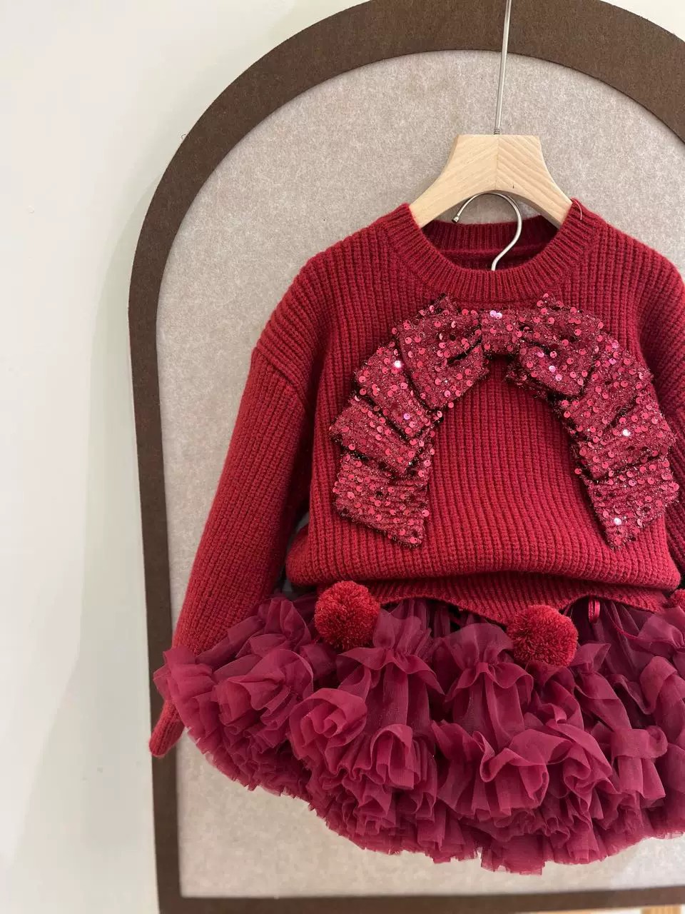 Demi-season children's red knitted sweater with bow