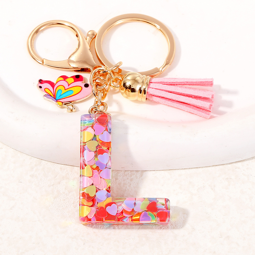 2024 puntos transfronterizos de resina de sequilla rosa 26 letras inglesas llavero colgante mariposa fringe accesorios