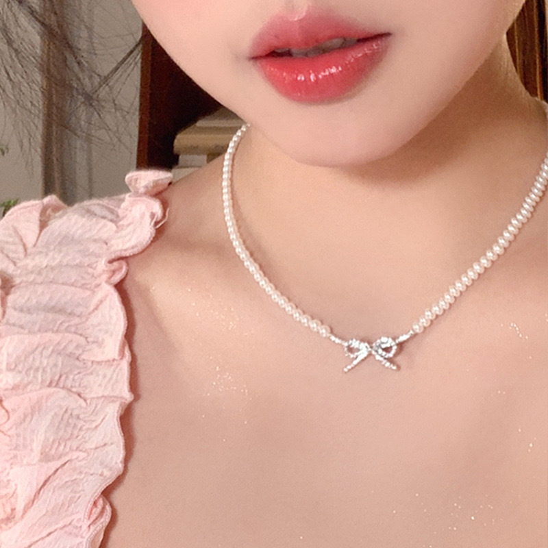 Elegant cute necklace with zircon with bow from pearl