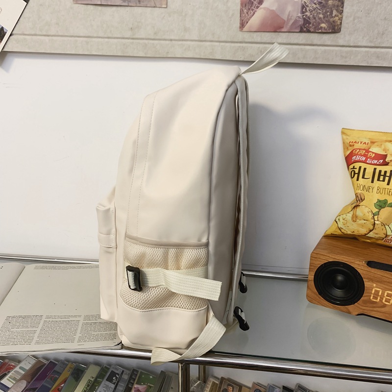 Fábrica al por mayor 2023 nueva mochila de PU de gran capacidad para estudiantes de secundaria de ocio, mochila de viaje al aire libre literaria simple