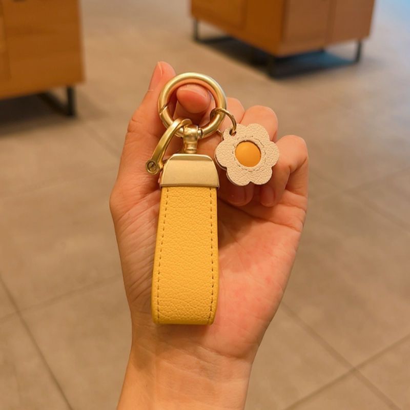 Estilo francés de alta gama de cuero fresco cuerda coche llavero simple lindo clave colgante Pequeño Libro Rojo mismo estilo girasol