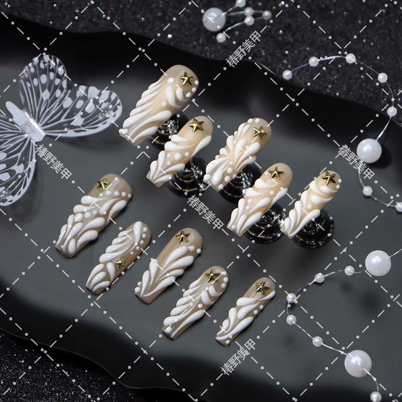 Nude color luminous 3D embossed star decoration extended ladder finished press-on nails wholesale, same style as popular on social media Nude color luminous 3D embossed star decoration extended ladder finished press-on nails wholesale, same style as popular on social media