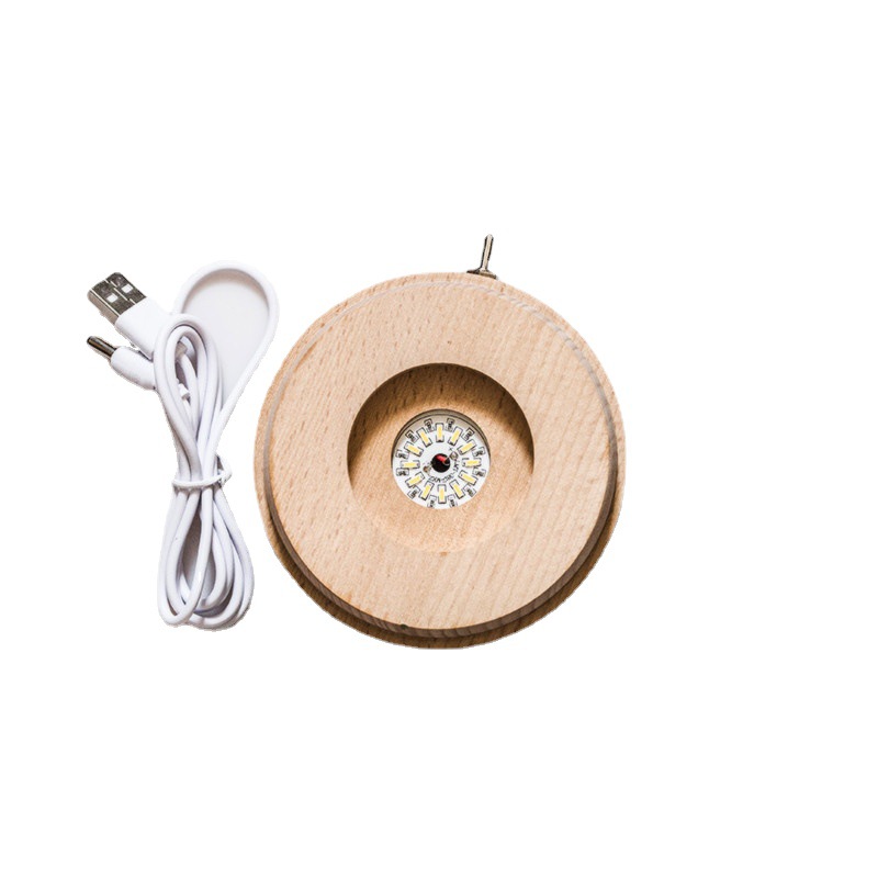 Bola de cristal giratoria caja de música LED base luminosa luz de la noche de dibujos animados pequeña base de la decoración