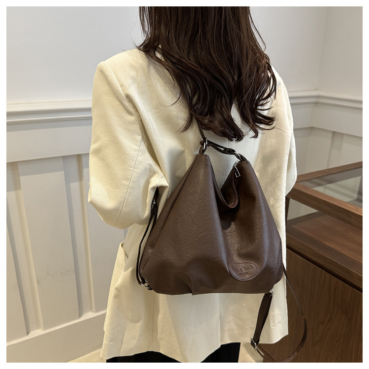 The 2024 new pleated tote bag is a large-capacity casual and fashionable backpack for women, featuring multi-functional texture and a single-shoulder crossbody bag undefined