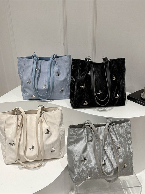 Bolsos de cubo de arco de alta calidad para mujeres 2024 verano nuevo estilo extranjero nicho bolso de hombro de moda bolso de mujer