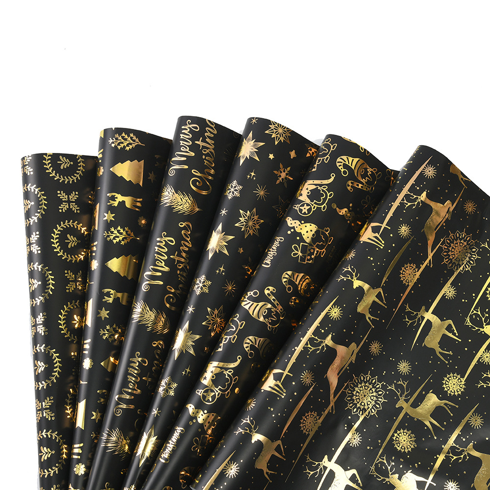 Nuevo papel de regalo de oro negro de Navidad transfronterizo papel de cobre brillante copo de nieve papel de regalo de ciervo de Navidad papel de regalo