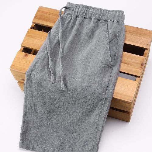 Summer lightweight khaki cotton-linen capri pants for men: solid-color, loose-fit, straight-leg design with elastic waistband—perfect for casual beach wear.