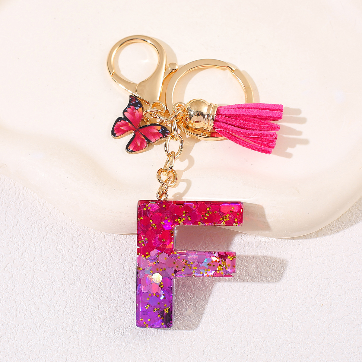 Transfronterizo Amazon 26 letras llavero de goteo de goma esquinilla gradiente letras mariposa llavero bolso de mujer colgante