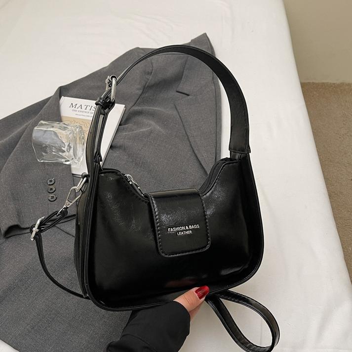 Nicho Zhong simple y versátil bolso de brazo para mujeres 2025, nuevo estilo de moda casual bolso de hombro de alta sensación bolso de media luna de mano