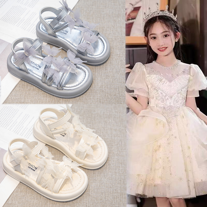Sandalias de niñas 2026 verano nuevo niño arco princesa zapatos de moda para niños grandes zapatos de playa versátiles zapatos