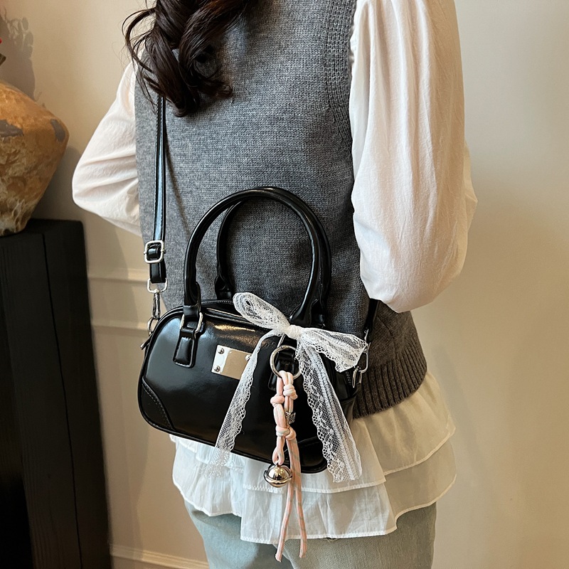 Bolsa de bolos portátil coreana de nicho para mujeres 2026 nueva textura mochila de hombro de estilo extranjero para viajar simple