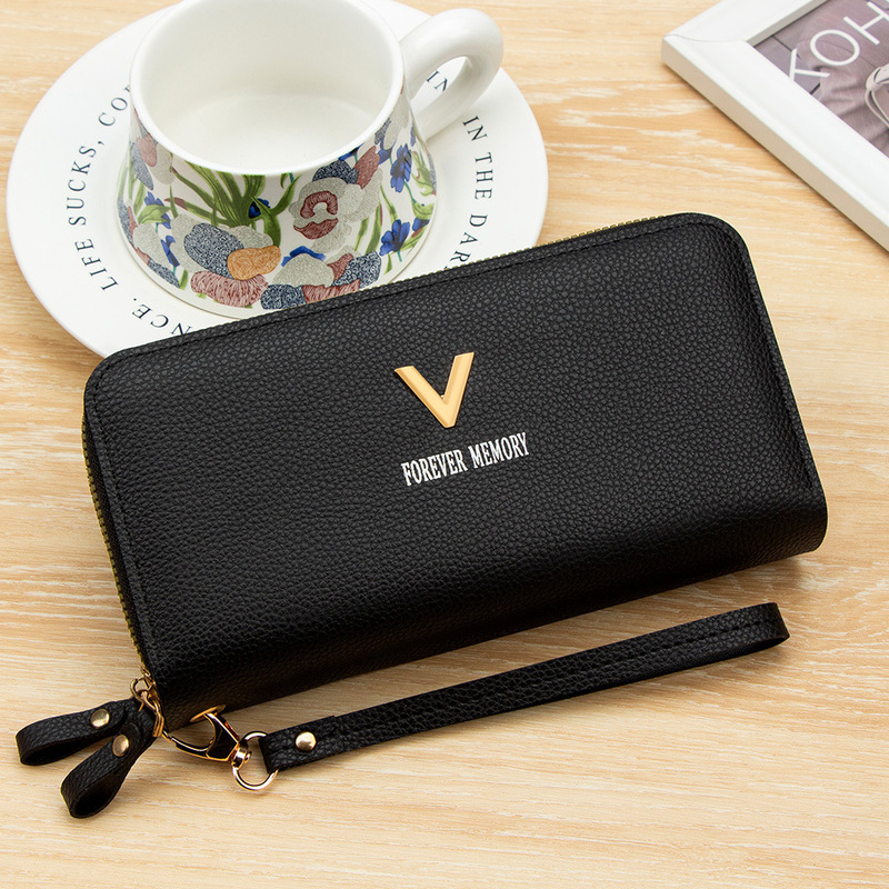 Solid-color, lychee-patterned women’s long wallet with double zippers, V-shaped hardware, large capacity, multiple compartments, and a wrist strap for holding a phone and money Solid-color, lychee-patterned women’s long wallet with double zippers, V-shaped hardware, large capacity, multiple compartments, and a wrist strap for holding a phone and money