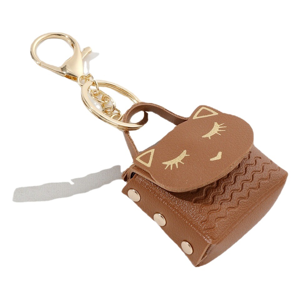 Ruoguo cuero gato cabeza monedero llavero moda coche bolsa pareja llavero pequeño colgante al por mayor