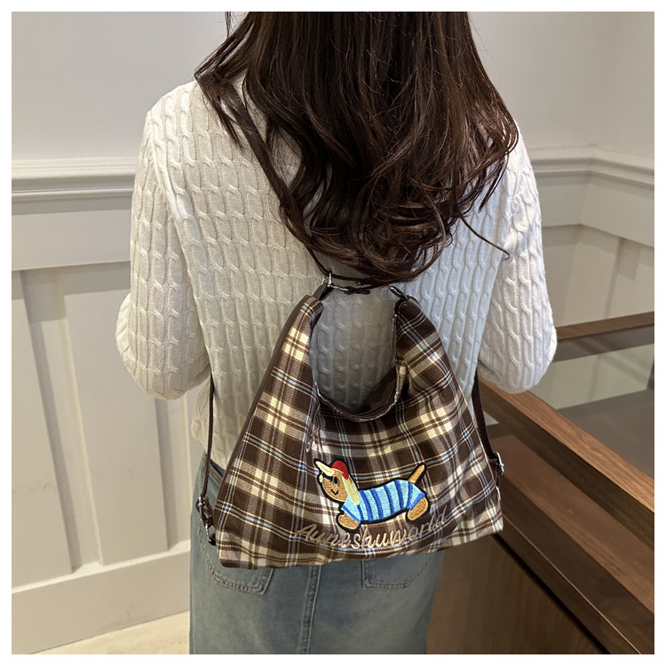 A new 2024 trendy and stylish backpack for women, featuring a cartoon checkered single-shoulder crossbody bag and a tote bag undefined