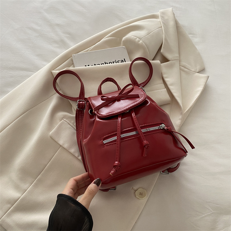 Mochila de nicho coreana para mujer, verano 2024, nueva mochila de moda, bolso de cubo portátil de un solo hombro de todo fósforo