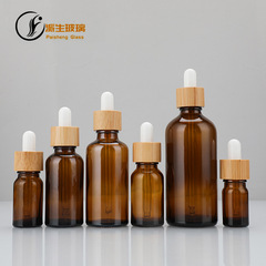 茶色の竹の木の輪のガラスのスポイトの瓶のゴムの頭のスポイトの瓶の精華液の化粧品の分注の瓶の印刷のロゴの卸売り