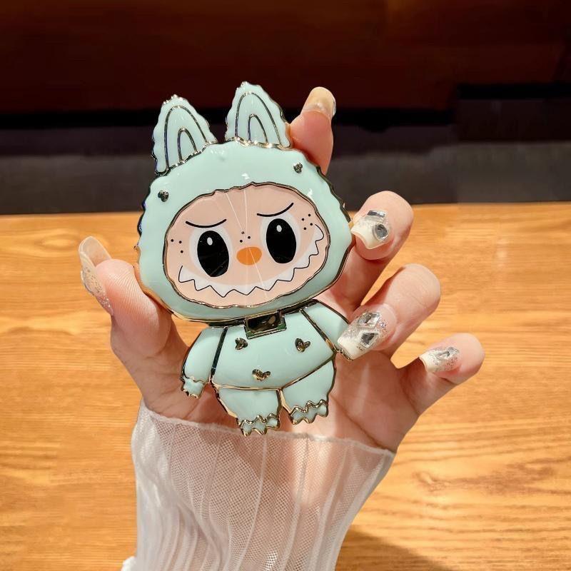 漫画かわいいラブブ携帯電話ホルダーラブブ化粧鏡ホルダーミラー携帯電話ホルダーは回転して折りたたむことができます|undefined